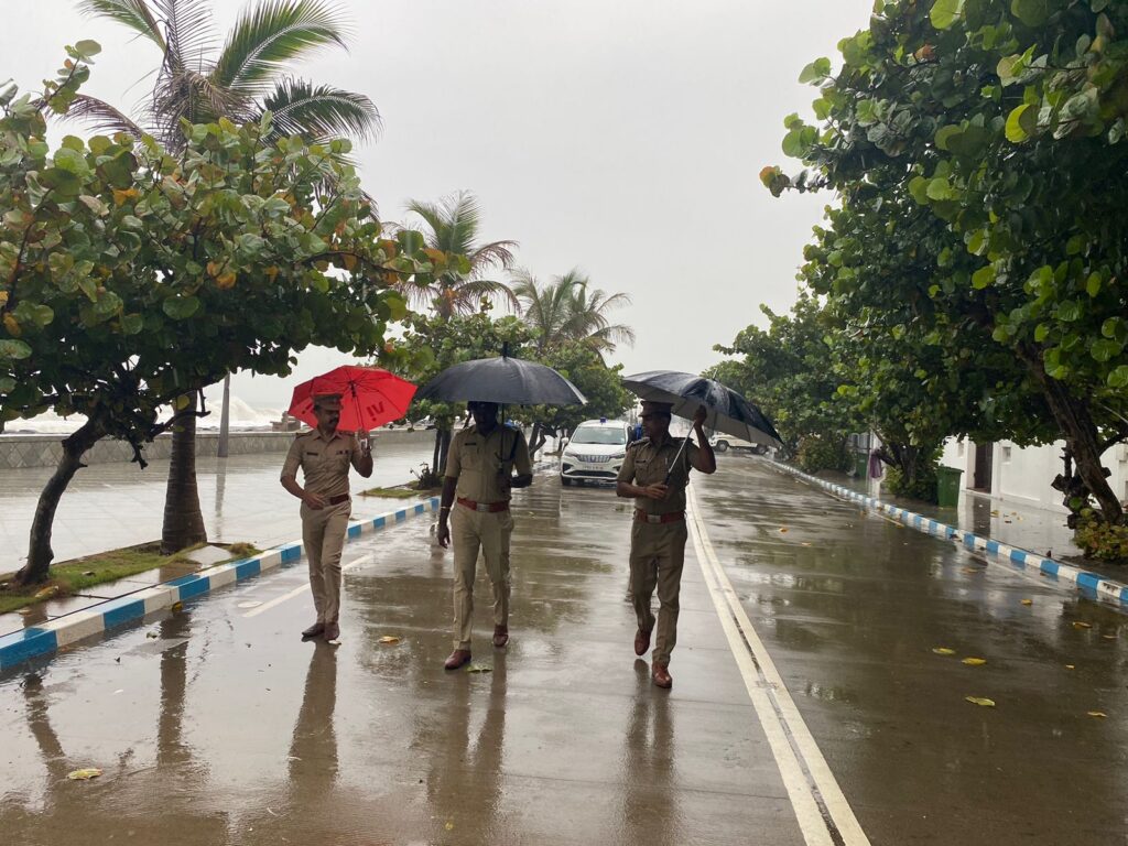 Heavy rainfall in Tamil Nadu as Cyclone Fengal approaches, with waterlogged streets and residents staying indoors.