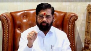 Eknath Shinde, caretaker Chief Minister of Maharashtra, in a hospital setting with medical staff, symbolizing health concerns amidst a backdrop of political discussions.